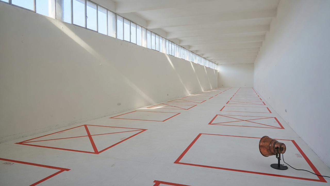 Exhibition hall with vermilion tape marking empty lots